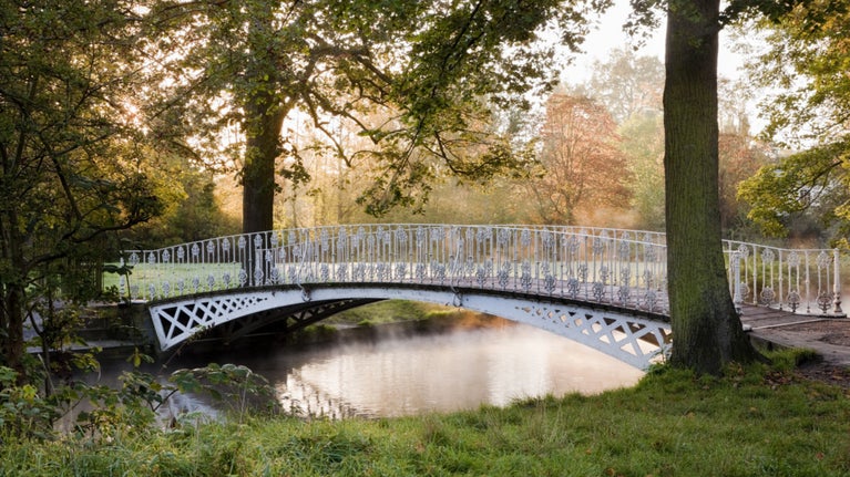 The cast iron bridge over the River Wandle in Morden Hall Park, London